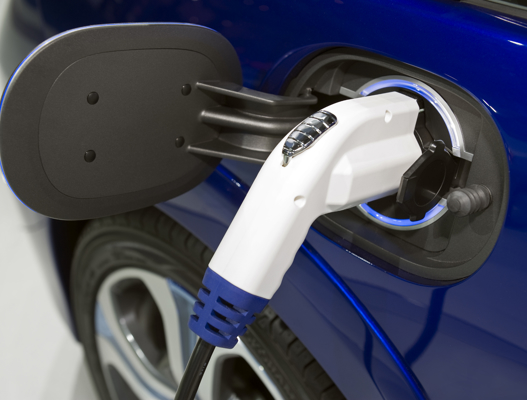 Blue electric car being charged